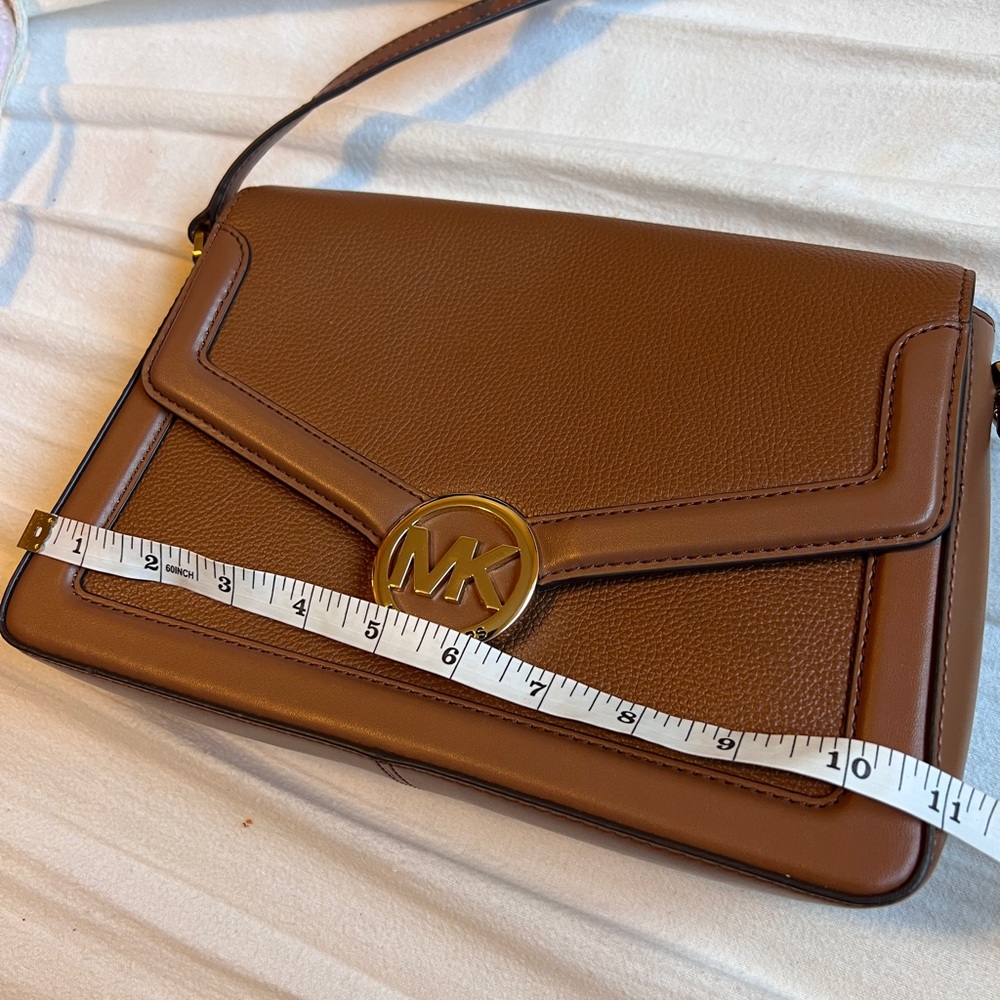 MK full grain leather cross body. Never been used.